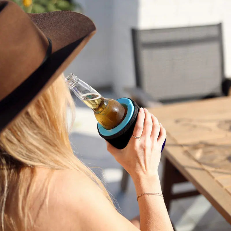 Woman wearing cowboy hat drinking bottled beverage from black Wrapsulator Regular